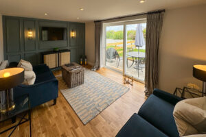 Garden room at Penjerrick with seating and french doors onto patio with patio furniture