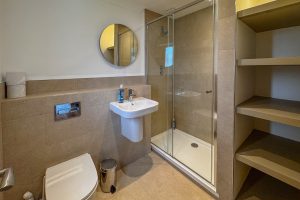 The ensuite to the master king bedroom at Tregarne with shower cubicle, toilet and wash basin