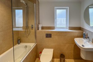 The bathroom off the entrance hall at Tregarne with bath, toilet and wash basin