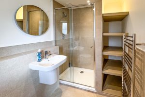 The ensuite to the master king bedroom at Tregarne with shower cubicle, toilet and wash basin