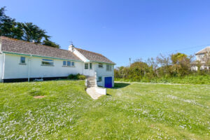 Front exterior Thalassa from the grassed garden with steps up to the front door