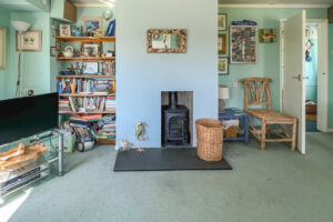 Lounge area at Thalassa with television and wood burner