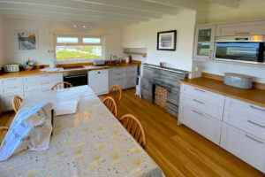Kitchen and dining area at The Buck with appliances and table and chairs