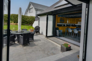 Views from bi-fold doors across the patio through to kitchen at Morvoren