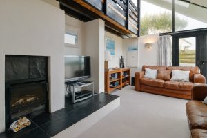 Living room at Morvoren with TV and wood burner