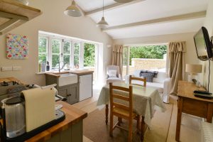 Open plan kitchen, lounge and dining area at Pensile House Cottage