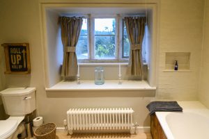 Bathroom with feature stone windows at Pensile House Cottage