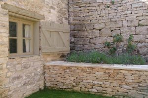 Exterior wooden shutters on the windows at Pensile House Cottage