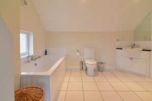 Ensuite Bathroom to the master bedroom at Parc Vean showing bath with hand held shower, toilet and wash hand basin