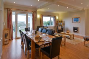 Dining and lounge area at Parc Vean with dining table and chairs and lounge seating