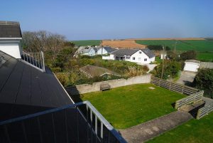Aerial view of the front garden at Parc Vean with path to beach road and view of farmland