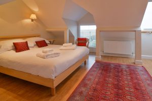 King bed in master bedroom on first floor at Parc Vean