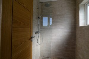 Overhead, walk in shower in utility room at Pendoric