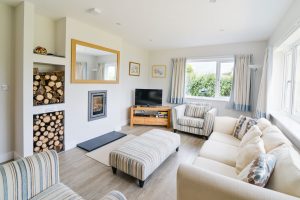 Small living room on the ground floor at Pendoric with TV and log burner