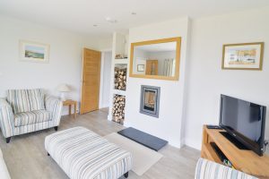Smaller lounge on the ground floor at Pendoric with TV and log burner