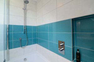 Overhead shower and bath in the en suite from Bedroom 4