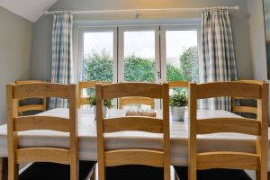 Dining area at Penpor with bifold doors leading to the rear garden