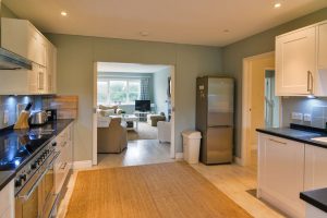 Spacious kitchen leading into lounge area at Penpor
