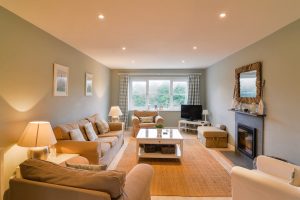 Ground floor lounge with TV and log burner at Penpor