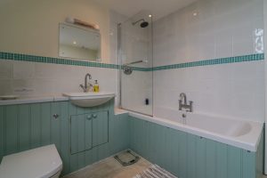 Bathroom on the first floor at Penpor with overhead shower and bath