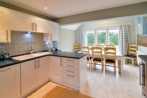 Kitchen and dining area with bifold doors at Penpor