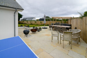 Rear exterior at Ridegegove with ample seating and BBQ