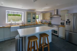 Well equipped kitchen with an island and bar stools at Ridgegrove