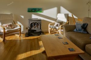 Lounge area at Sailaway with seating and imitation wood burner