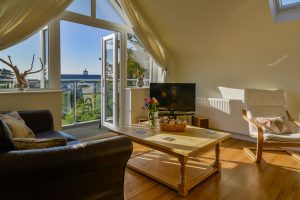 Lounge area at Sailaway with patio doors to balcony and television