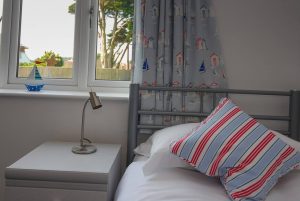 One of the twin beds on the lower level garden floor at Sailaway