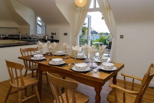 Dining area and patio doors onto balcony at Sailaway