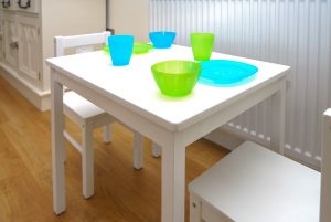 Small children's table and two chairs in open plan living area at Sailaway