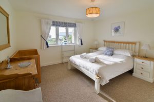 Lower garden level kingsize bedroom with cot at Sailaway
