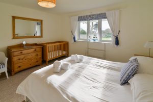 Lower garden level kingsize bedroom with cot at Sailaway