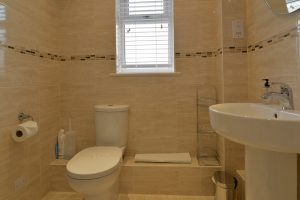 Ground floor ensuite shower room at Sailaway with toilet and sink