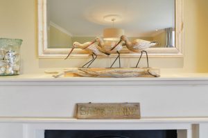 Wading bird ornaments on fireplace at Santa Marina