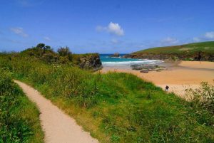 View across beach and ocean from coastal footpath close to Santa Marina