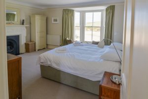 Master superking bedroom on first floor at Santa Marina with bay window and view over the beach