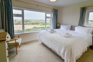 Ensuite superking bedroom at South Corner with dual aspect and large window with view overlooking Treyarnon Bay