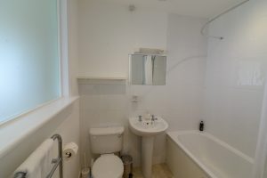 Ensuite bathroom from the master superking bedroom with bath, shower over, toilet and wash basin.