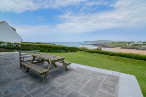View over the beach and grassed lawn from the patio at South Corner