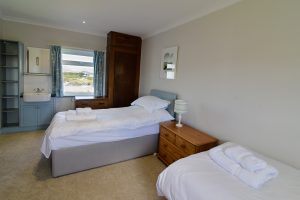 Triple bedroom at South Corner with view over the beach from the window
