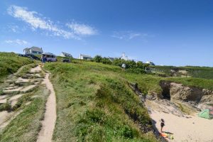 View up the coastal footpath from the beach to the ice cream hut with South Corner in the background