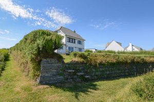 View of the house from the footpath at South Corner with access over the hedge into the garden from the footpath