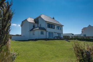 Exterior of the beachside of the house from the corner of the front grassed lawn