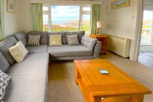 Seating in the lounge at The Buck with view towards the ocean