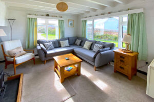 Lounge at The Buck with seating and large windows to front and side of the house