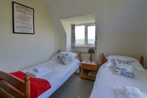 The second of the twin bedrooms at The Buck with view towards the beach and ocean