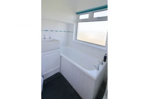 Ground floor bathroom off the utility area at The Buck with wash basin bath and shower cubicle only