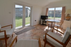 The garden room at The Buck with seating and tv